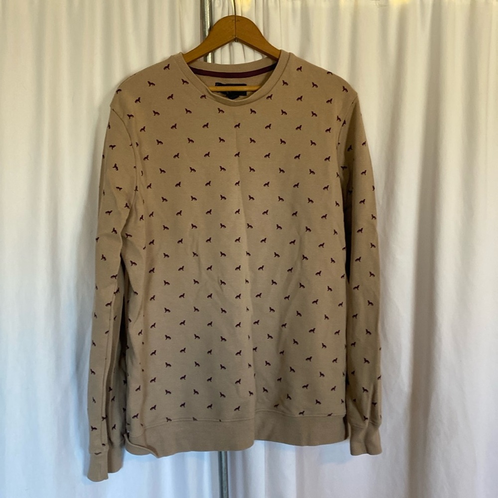Tan sweatshirt with wolf pattern